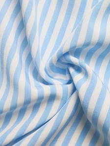 Close-up of lightweight blue and white striped fabric showing soft cotton texture and weave
