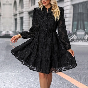 Elegant black long sleeve tiered dress with floral flocking and waist tie