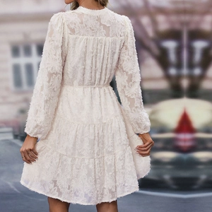 Detail of a beige tiered lace dress showing the exquisite layered texture and back view