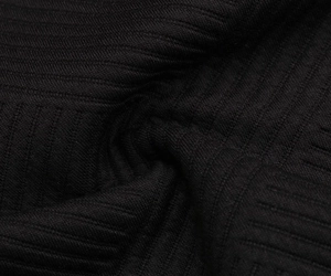 Detailed close-up of premium black ribbed knit fabric showing texture and soft material