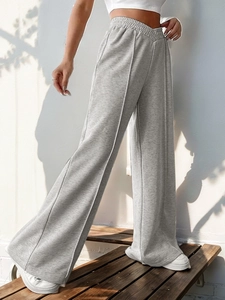 Detail of high waist V-shape elastic waistband on grey wide-leg lounge trousers