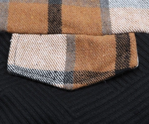 Detailed close-up of plaid patchwork and stitching on casual black long sleeve hoodie