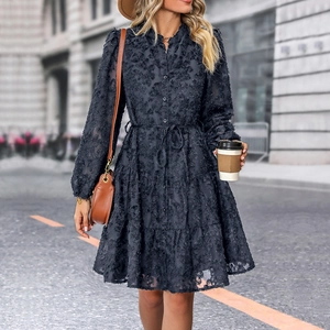 Close-up of textured dark grey long sleeve dress with layered cake skirt and buttons