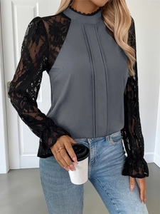 Detail of grey top with black floral lace sleeves and delicate high neck trim