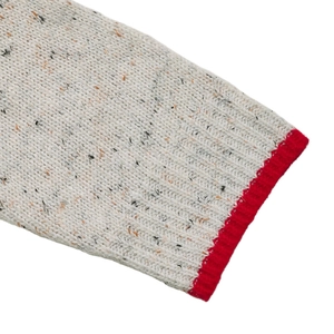 Detailed macro view of Donegal oatmeal knit fabric with vibrant red ribbed cuff finish