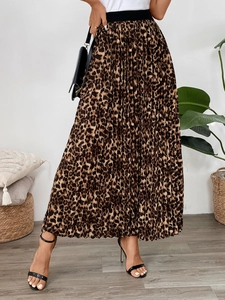 Detailed view of leopard print pleated maxi skirt featuring a wide black elastic waistband