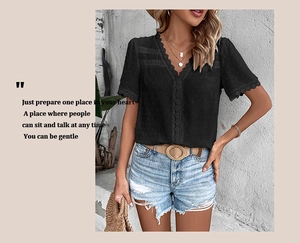 Detail of black V-neck Swiss dot blouse with delicate lace trim on sleeves and neckline