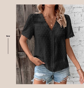 Detail of V-neck Swiss dot top with black lace trim and intricate embroidery texture