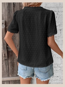 Detail of black Swiss Dot summer blouse with intricate lace trim on sleeves and back