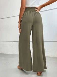 Detailed back view of high-waisted wide-leg trousers in olive green crinkle fabric