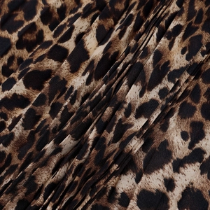 Close-up of leopard print pleated fabric showing texture and brown pattern detail