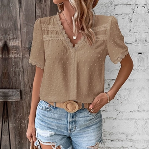 Detail of V-neck beige Swiss dot chiffon blouse with delicate crochet lace trimming