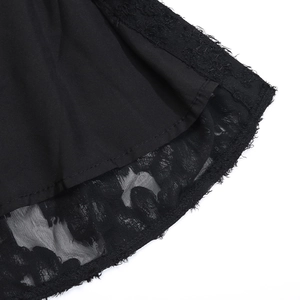 Close-up of vintage black dress hem featuring intricate lace and delicate eyelash fringe