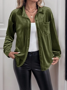 Close-up of dark green velvet shirt featuring a classic collar and front patch pocket