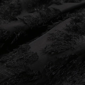 Close-up of the black dress showing high-quality 3D flocked lace fabric and fuzzy texture
