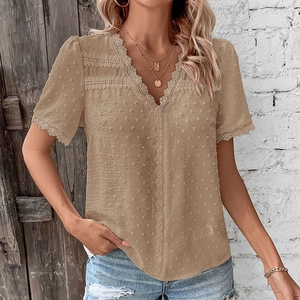 Detail of khaki V-neck shirt showing Swiss dot texture and delicate lace trim accents