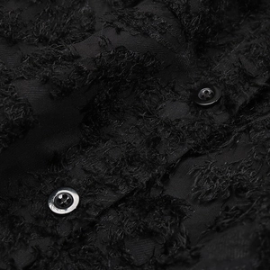 Detailed close-up of black feather-textured jacquard fabric with smooth round buttons