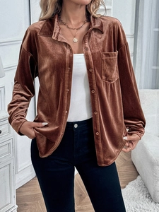 Detail of soft brown velvet texture and functional chest pocket on autumn women shirt