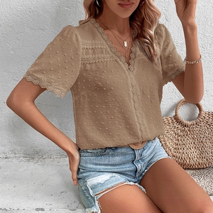 Detail of V-neck Swiss dot blouse with lace trim and elegant khaki textured fabric