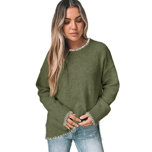 Detailed view of moss green knit sweater with contrast white hand-stitched edging on cuffs