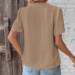 Detailed view of women's khaki Swiss dot top with delicate lace trim on sleeves