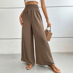 Women's dark brown wide leg trousers with a smocked high waist and pleated texture