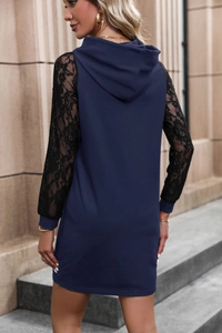 Detail of navy blue hooded dress featuring floral black lace sleeves and slim fit design