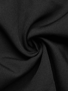Close-up of black high-quality twill fabric texture with elegant spiral fold detailing