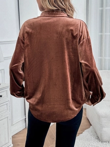 Macro shot of brown velvet shirt back showing the fabric texture and loose fit silhouette