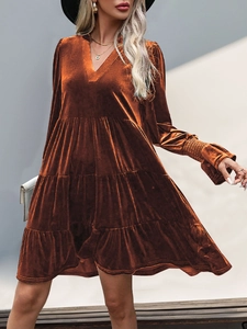 Detail of V-neck brown velvet dress showing tiered ruffle skirt and elastic cuffs