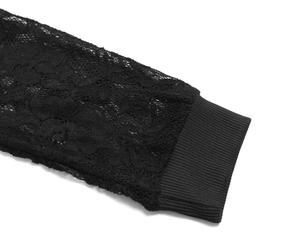 Detailed close-up of long black lace sleeve with elastic ribbed cuffs on hooded dress