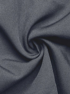 Detail of dark charcoal gray textile texture with elegant spiral fabric folds