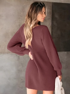 Detail of burgundy knit dress featuring textured lantern sleeves and soft knitted fabric