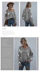 Detail of grey V-neck knit sweater with white stars and stylish distressed fringe hem