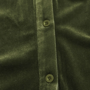 Detail view of army green velvet fabric texture with buttons on minimalist long sleeve shirt