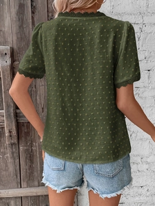 Detail of Swiss dot texture and lace trim on back of women's dark green V-neck summer blouse
