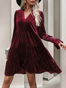 Detailed view of the V-neckline and tiered velvet layers on this wine red party dress