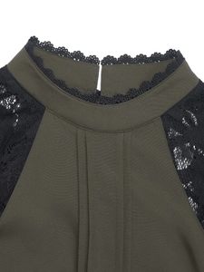 Detail of high neck lace trim and pleated shoulders on olive green long sleeve shirt