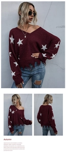 Detail of burgundy V-neck star pattern knit sweater with distressed frayed hem and fringe
