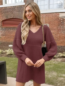 Close-up of wine red V-neck knit dress showing lantern sleeves and ribbed texture details
