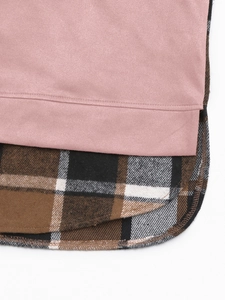 Détail de couture entre suédine rose et tissu à carreaux avec ourlet courbé précis