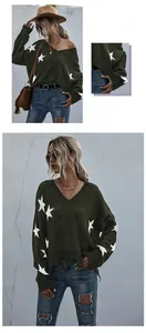 Detail of dark green V-neck knit sweater featuring white stars and frayed fringe hemline