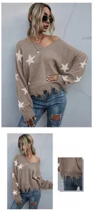 Detail of V-neck brown sweater with star patterns and frayed hem distress texture
