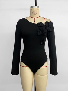 Detail of 3D floral applique on black one-shoulder long sleeve slimming bodysuit