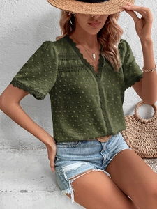 Close-up of Swiss dot fabric and hollow lace trim on olive green V-neck summer blouse
