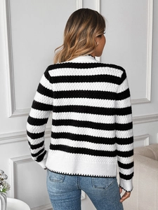 Close-up of black and white striped knitted sweater with 3D wave texture on back view