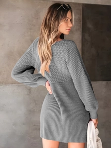 Detailed close-up of grey knit dress featuring textured waffle and ribbed stitch patterns