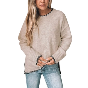Women's crewneck long sleeve sweater in beige with contrast black stitching and side slits
