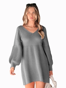 Close-up of grey knit dress with V-neckline and lantern sleeves in waffle texture