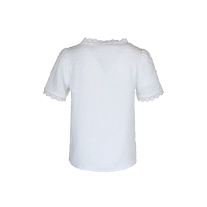 Detail view of Swiss dot textured fabric and delicate lace trim on the white blouse back